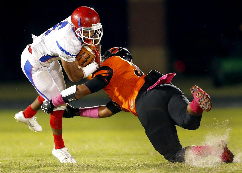 Douglass’ Xavier tackles John Marshall’s Jerome Thomas
